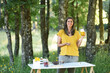 Naturopathic woman with medicinal plants on outdoor work table