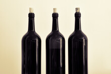 Black And White Photo In Antique Style With Three Empty Wine Bottles