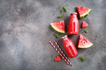 Sticker - Fresh tasty watermelon smoothie in glass bottles on stone background. Top view. Copy space.