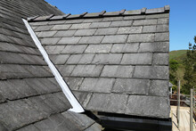 A Close Up View Of A Slate Roof Over A Dormer Window On A House In Wales, UK.