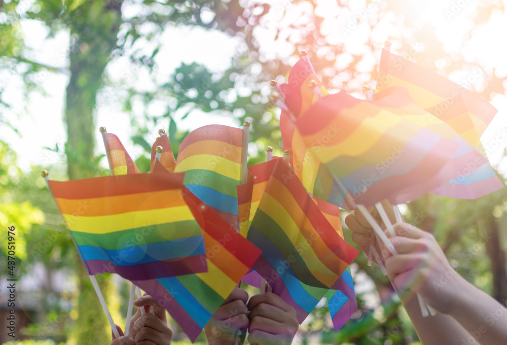 LGBT, pride, rainbow flag as a symbol of lesbian, gay, bisexual, transgender, and queer pride and LGBTQ social movements in June month - obrazy, fototapety, plakaty 