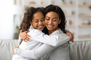 Wall Mural - Beautiful black lady hugging her cute little daughter