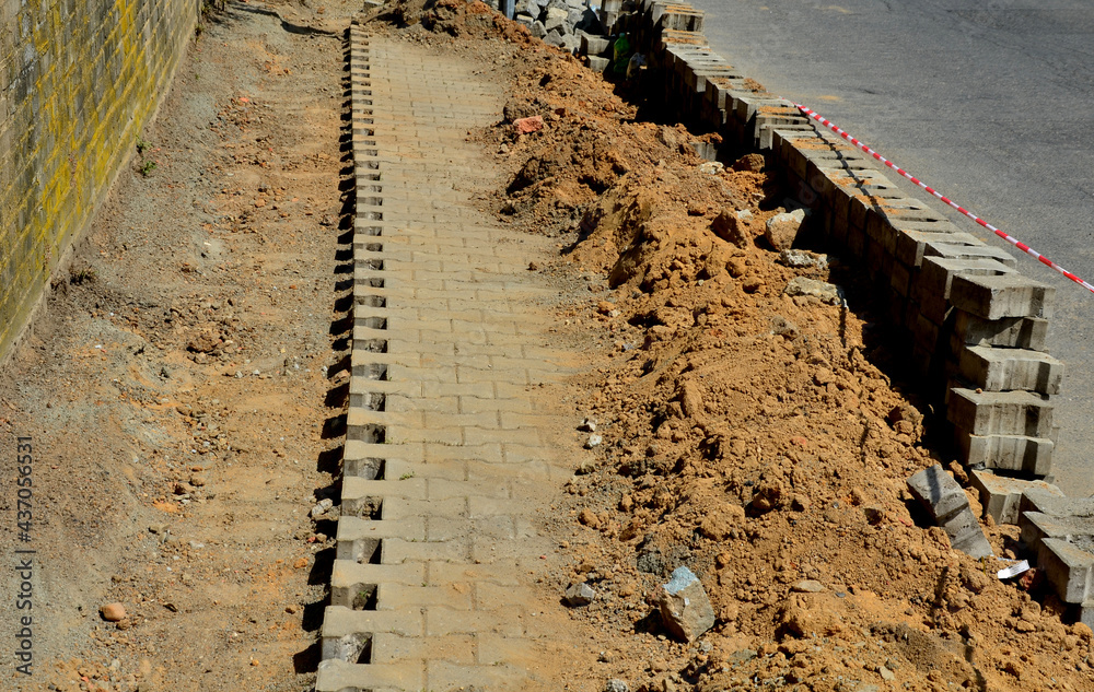 disassembly of interlocking paving and laying of cable electricity ...