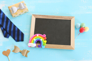 Wall Mural - top view image of fathers day composition with vintage father's accessories and blackboard