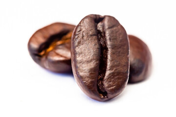 Brown roasted coffee beans isolated on white background.