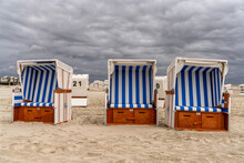 Colorful Beach Baskets On An Idyllic Golden Sand Beach On The German Wadden Sea Coast Under An Expressive Sky