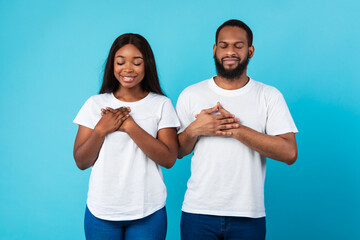 Wall Mural - Black couple keeping hands on chest at studio