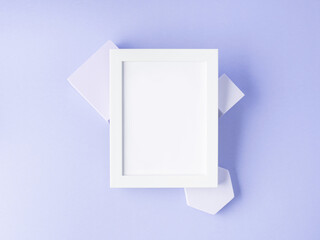 White empty frame for text on purple geometric cubes, flat lay