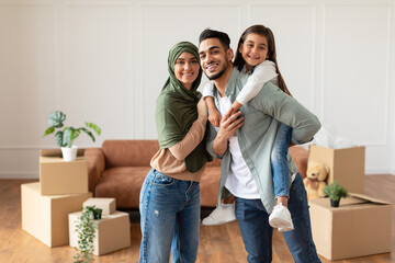 Sticker - Happy muslim family looking at camera, posing on moving day