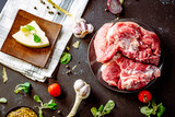 Fototapeta  - Fresh pork with vegetables on dark background. Fresh meat kitchen