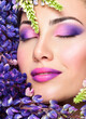 © Svetlana Fedoseeva - Beautiful woman face surrounded by violet flowers. Spring Flower. Springtime. Professional makeup,