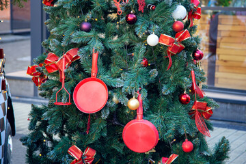 New Year tree on the city street, decorated with kitchen utensils. Christmas tree design