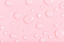 Cosmetic Liquid Transparent Gel With Bubbles On Pink Background. Flat Lay Style.