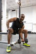 © Alfredo López - African American man strengthening his body doing weight training in gym. Fitness concept.
