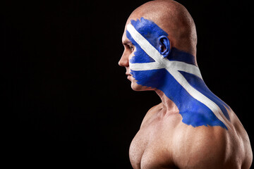 Wall Mural - Scotland fan. Soccer or football athlete with flag bodyart on face. Sport concept with copyspace.