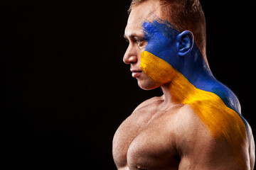 Wall Mural - Ukraine fan. Soccer or football athlete with flag bodyart on face. Sport concept with copyspace.