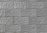 Fototapeta  - Texture of a decorative stone wall made of gray rectangular blocks