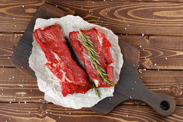 Wall Mural - Beef tenderloin on wooden board on wooden table