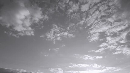 Wall Mural - sunset time and clear blue sky with some white fluffy clouds. black and white real time 4k video foo