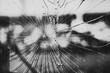 A very dirty shattered window with lines radiating from the point of impact. A black and white image