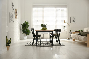 Wall Mural - Stylish wooden dining table and chairs in room. Interior design