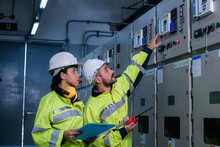Engineer checking and inspecting at MDB panel , working with electric switchboard to check  medium Voltage Switchgear working in Main Distribution Boards factory.