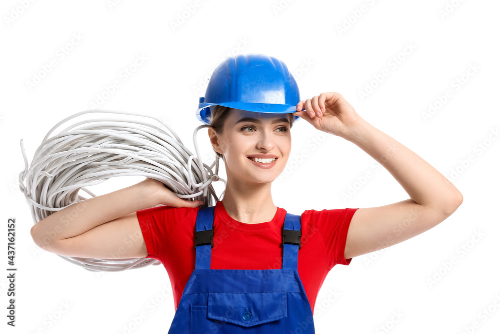 Young female electrician with cables on white background