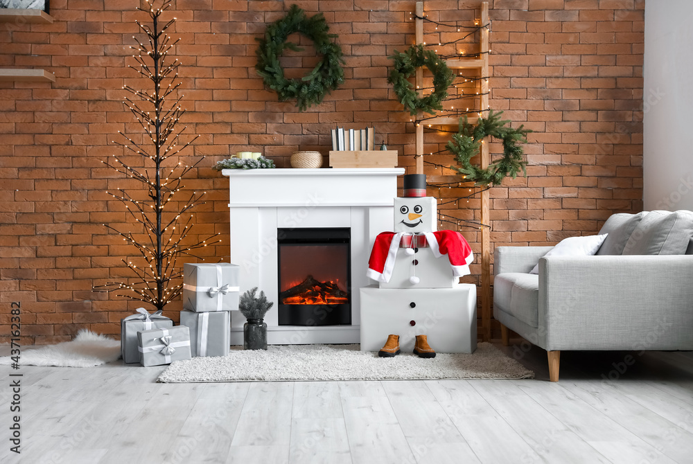 Interior of living room with fireplace and decorative snowman - obrazy, fototapety, plakaty 