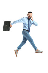 Poster - Jumping young man talking by mobile phone on white background