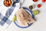 Fototapeta Koty - Plate with tasty quesadillas on light background