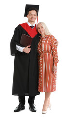 Happy male graduation student with his mother on white background