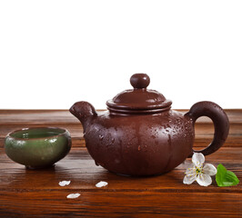 Wall Mural - Cup of green tea and clay teapot with cherry flowers isolated on a white background. 