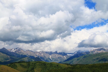 clouds over the mountains with snow