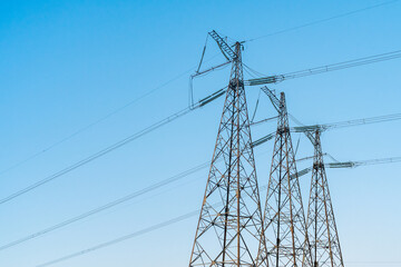 Power line stations against a blue sky