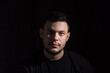 © АртГЛОБУС - Portrait of a young dark-haired man on a dark background