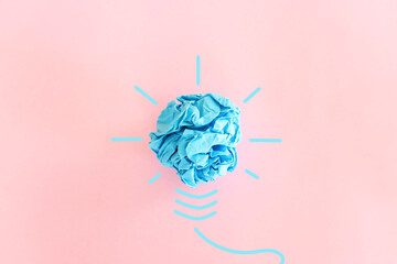 Wall Mural - Education concept image. Creative idea and innovation. Crumpled paper as light bulb metaphor over pink background