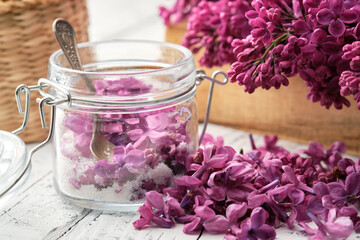 Wall Mural - Making lilac sugar. Lilac flowers and sugar in a preserving jar. Bunch of blossom Syringa on background.