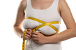 © vladimirfloyd - a woman measures with a measuring tape her large breasts