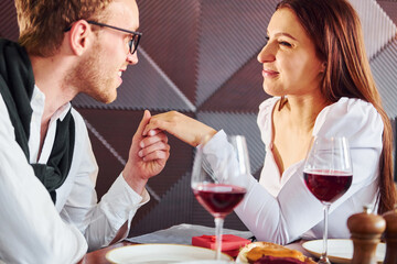 Couple of young guy and adult woman. Indoors of new modern luxury restaurant