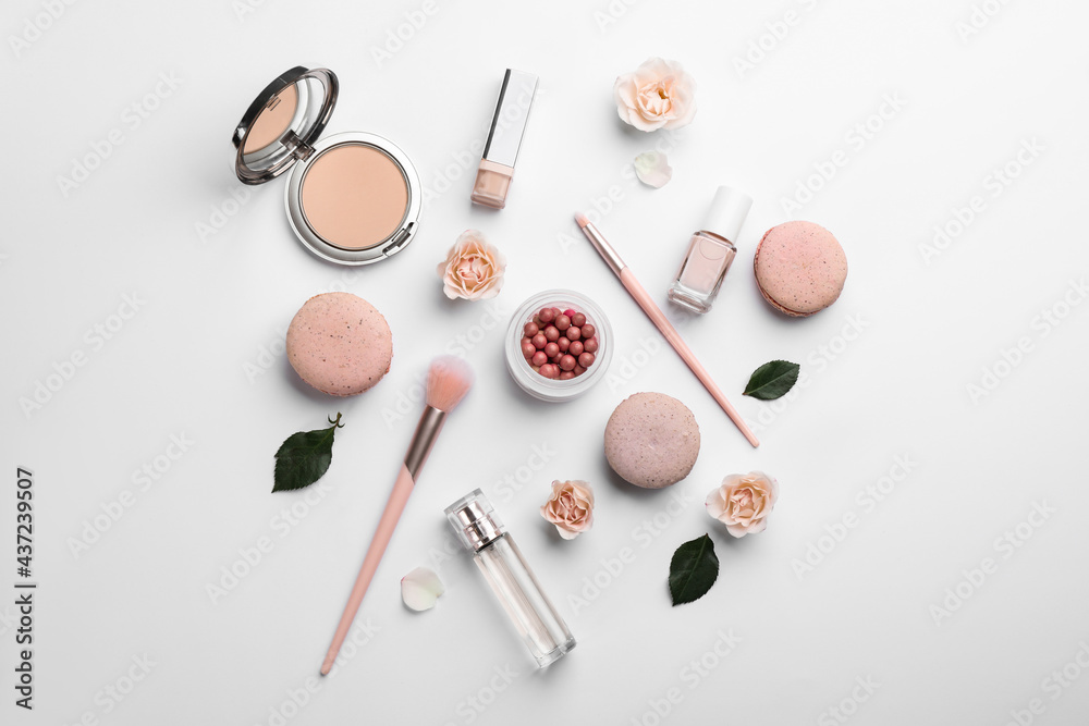Flat lay composition with makeup products, roses and macarons on white background - obrazy, fototapety, plakaty 
