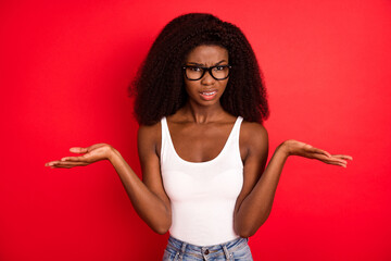 Sticker - Photo of young afro girl unhappy negative confused no answer clueless isolated over red color background