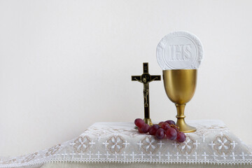 Wall Mural - The Feast of Corpus Christi Concept. Holy communion and cup of glass with red wine on table.