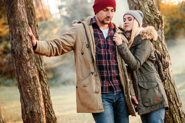 Wall Mural - Hiking couple with backpack walking in the forest and exploring outdoors. Freedom and active travel concept.