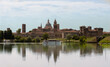 Panoramic view of the city of Mantua with the Mincio river in front. Boats sailing on the Mincio ton tourists and passengers. Lombardy region