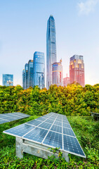 Wall Mural - ecological energy renewable solar panel plant with urban landscape landmarks in sunrise