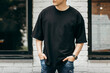 Man wearing black blank t-shirt with space for your logo or design. Mock up