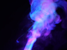 Abstract Colour Series. Composition Of Colourful Smoke In Motion. Fusion Of Blue And Purple Mist Isolated On A Dark Background To Inspire Creativity.