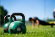 kettlebells in green grass - fitness concept outdoors 