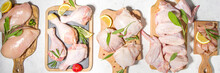 Various Raw Chicken Meat Portions. Set Of Uncooked Chicken Fillet, Thigh, Wings, Strips And Legs On White Cooking Table Background With Spices