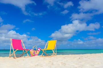 Wall Mural - Beach chairs, beach bag, flip flops, beach towel on the shoreline, beautiful beach